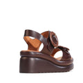 The EOS Menorcas Chestnut Brown Leather Wedge Sandal features a thick sole, large buckle strap, open toe, and anatomical footbed for enhanced arch support, shown against a white background., 49568, 49569, 9321191310664, 9321191310671, 9321191310688, 49573, 49574