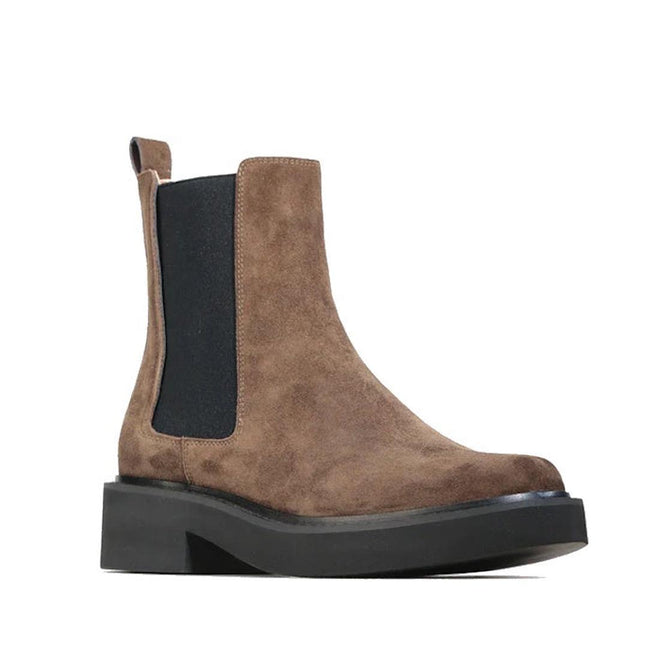 The EOS Womens Leilin Suede Kalamata Brown Ankle Pull On Boot features brown suede, a black elastic side panel, back pull tab, and thick black rubber stacked heel sole, displayed on a white background.