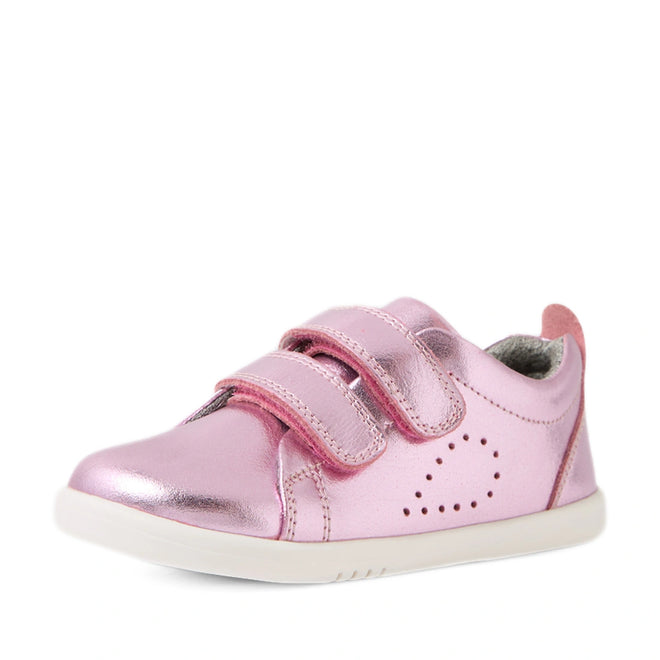 Shiny pink metallic leather sneakers for toddlers featuring two Velcro straps, side perforations, a light-colored sole, and a soft inner lining—the Bobux Iwalk Toddlers Grass Court Pink Metallic Leather Trainer combines playful style with comfort for little feet.