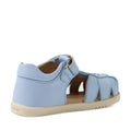 The Bobux IWalk Holly Toddlers Sandal in Skyway Blue features a closed toe, closed heel, and open sides. Made from quick-drying leather, these sandals have a Velcro strap for easy fastening, a beige flat sole, and visible stitching on the heel.
