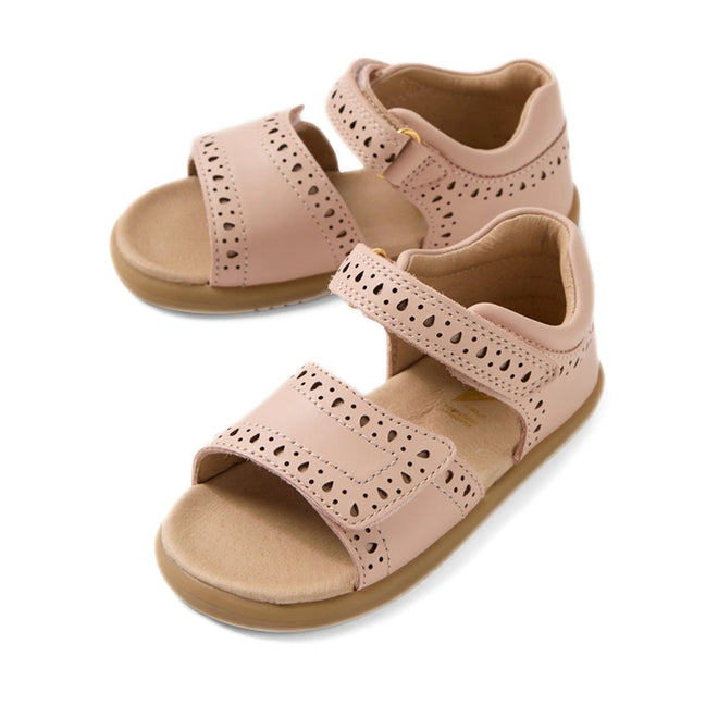 A pair of Bobux IWalk Logan Toddlers Sandal in Cameo Rose Pink, featuring open toes, perforated patterns, and Velcro straps. These tan-colored leather sandals include a soft cushioned footbed for added comfort.