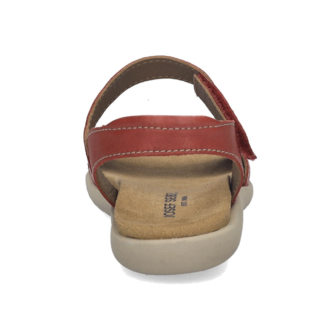 A close-up rear view of the Josef Seibel Juliet 03 Women’s Leather Comfort Sandal showcases a red leather upper paired with a beige cushioned sole, tan footbed, and prominent stitching details, all set against a white background. This stylish sandal highlights exceptional comfort and craftsmanship.