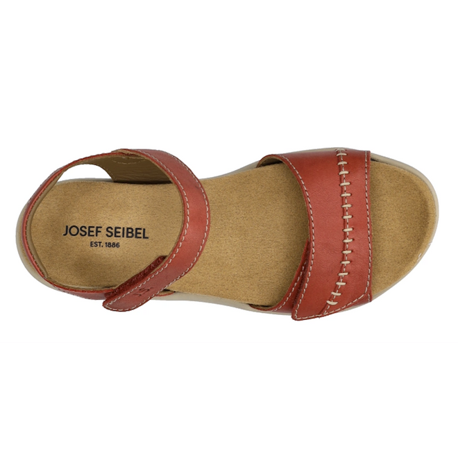 Top view of a single Josef Seibel Juliet 03 Women’s Leather Comfort Sandal in red-brown, featuring a velcro ankle strap, tan cushioned insole, and visible stitching on the front strap. “JOSEF SEIBEL EST. 1886” is printed on the insole—an elegant addition to any collection of women’s sandals.