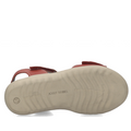 The image displays the bottom view of the Josef Seibel Juliet 03 Womens Leather Comfort Sandal in red leather, featuring a light beige sole. The sole showcases the JOSEF SEIBEL brand name printed in the center, along with a small smiley face near the heel, emphasizing this stylish and comfortable option for women’s sandals.