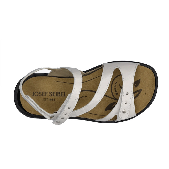 A top-down view of the Josef Seibel Ibiza 70 Women’s Leather Comfort Sandal in white shows a dual-strap design with metallic studs on one strap, a tan insole featuring a decorative leaf pattern, and a black sole., 4062838862096, 4062838862102, 4062838862119, 4062838862126, 4062838862133, 4062838862140