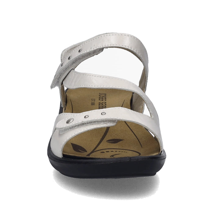 Front view of the Josef Seibel Ibiza 70 Women’s Leather Comfort Sandal in white, featuring two adjustable straps with visible metal studs and a cushioned insole adorned with a leaf pattern. Inspired by the classic Ibiza 70 design, these sandals showcase a stylish black sole that is slightly raised at the heel for enhanced comfort and modern appeal., 4062838862096, 4062838862102, 4062838862119, 4062838862126, 4062838862133, 4062838862140