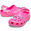 A pair of pink children's crocs clogs with a palm tree design Barbie style and jibbitz on a white background