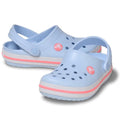 The Crocs Kids - Crocband Classic Clog Frost Blue Guava Youths features a frost blue color with pink accents and white soles, made from comfortable Croslite material, with ventilation holes and adjustable heel straps.