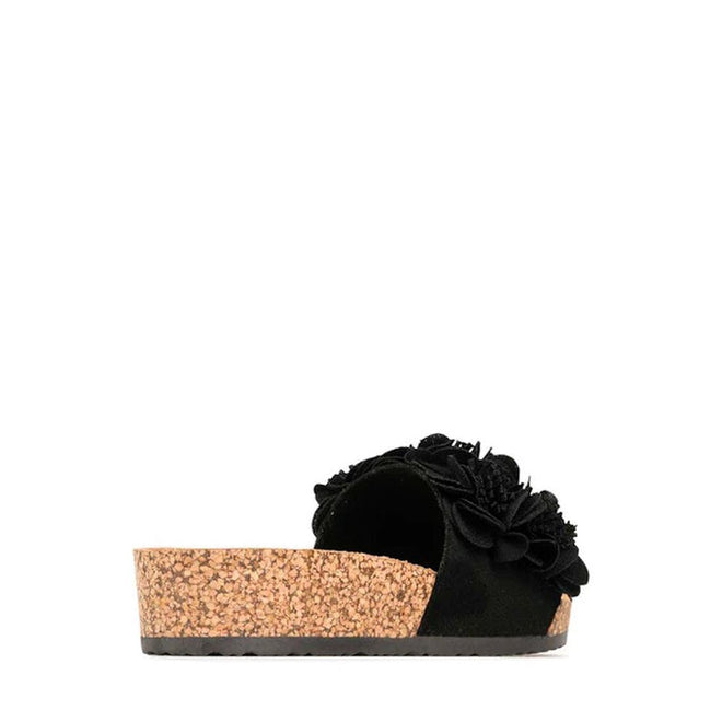 The Los Cabos Corsage Black Flower Women's Slides feature a black slip-on design with a thick cork wedge heel and floral accents on the upper, displayed from the side against a white background., 9321191212517, 9321191212524, 9321191212531, 9321191212548, 9321191212555, 46753