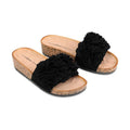 The Los Cabos Corsage Black Flower Women's Slides feature wedge heels with cork soles, beige footbeds printed with the Los Cabos brand, and black fabric straps decorated with layered floral embellishments., 9321191212517, 9321191212524, 9321191212531, 9321191212548, 9321191212555, 46753