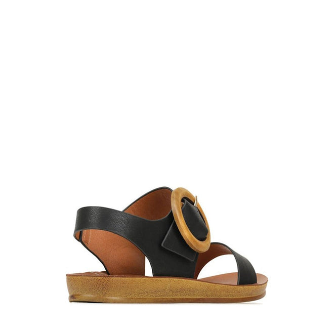 The Los Cabos Damas Black Light Flexible Sandal Jandal features wide black straps, a large wooden buckle on the side, a flat light brown sole, and an open toe and heel., 39784, 9321191213002, 9321191213019, 9321191213026, 9321191213033, 9321191213040, 9321191213057