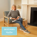Martha Stewart sitting on a chair in a living room with 'Skechers Martha Stewart'  slip in shoes branding.
196989023366,
196989023373,
196989023380,
196989023397,
196989023403,
196989023427,
196989023434,, 196989023366, 196989023373, 196989023380, 196989023397, 196989023403, 45607, 196989023427, 196989023434