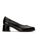 A side view of a  black leather Pitillos 103 court shoe with a stacked heel, made in Spain, displayed against a white background.
