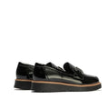 The Pitillos Womens Black Patent Slip On Loafer 10760 features chunky ridged soles, brown stitching, and metal detailing for a modern yet comfortable look—shown here against a white background., 8445191661319, 8445191661326, 8445191661333, 8445191661340, 8445191661357, 51930