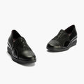 The Pitillos Womens Lycra and Patent Leather Shoe 10731 features a black wedge design with subtle curved patterns, removable insole, and low heels, displayed against a light background., 8445191655554, 8445191655561, 8445191655578, 8445191655585, 51923, 51924