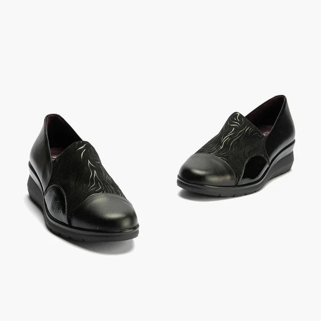 The Pitillos Womens Lycra and Patent Leather Shoe 10731 features a black wedge design with subtle curved patterns, removable insole, and low heels, displayed against a light background., 8445191655554, 8445191655561, 8445191655578, 8445191655585, 51923, 51924