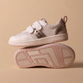 Two Pretty Brave River Hearts Leather Trainer sneakers in Pink Off White are shown. One stands upright, the other lies on its side to reveal the textured sole. Both feature light pink leather and velcro straps on a beige background., 9420075363854, 9420075363847, 9420075363830, 9420075363823, 9420075363816, 9420075363809, 50502, 50503, 50504, 50505