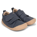 The Pretty Brave First Walker Toto Leather Trainer in Indigo Blue features flexible navy leather, beige rubber soles, and two Velcro straps per shoe, perfect for toddlers learning to walk. Displayed on a white background., 9420075366275, 9420075366268, 9420075366251, 50971