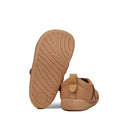 The Pretty Brave First Walker Toto Leather Trainer in Tan features soft soles; one shoe stands upright revealing its textured sole, while the other lies on its side displaying "PRETTY" embossed on the heel., 9420075366183, 9420075366176, 9420075366169, 9420075366152, 51694