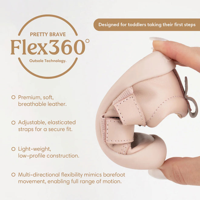 A hand bends the Pretty Brave First Walker Toto Leather Trainer in Dusky Pink, showing its flexible sole. Features include premium breathable leather, adjustable straps, lightweight design, and multi-directional flexibility for little ones’ first steps., 9420075366329, 9420075366312, 9420075366305, 50976