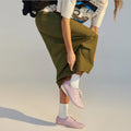 Person wearing green pants and lilac Rollie Derby Embossed shoes on a plain background.,
9781760778514,
9781760778538,
9781760778552,
9781760778484,
9781760778507,, 46062, 9781760778514, 9781760778538, 9781760778552, 9781760778484, 9781760778507
