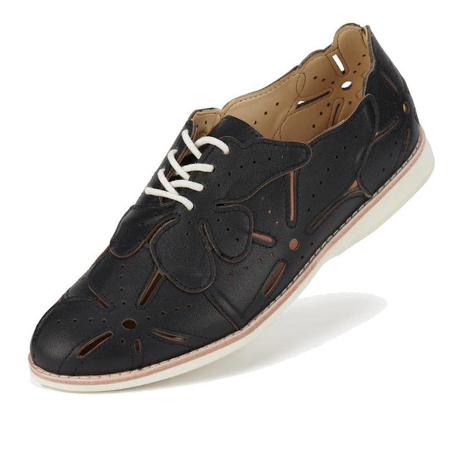 The Rollie Derby Applique Black Womens Leather Brogue Shoe features soft black leather uppers, decorative cutouts, a flower-shaped appliqué, white laces, and a white rubber sole—an Australian-designed classic.