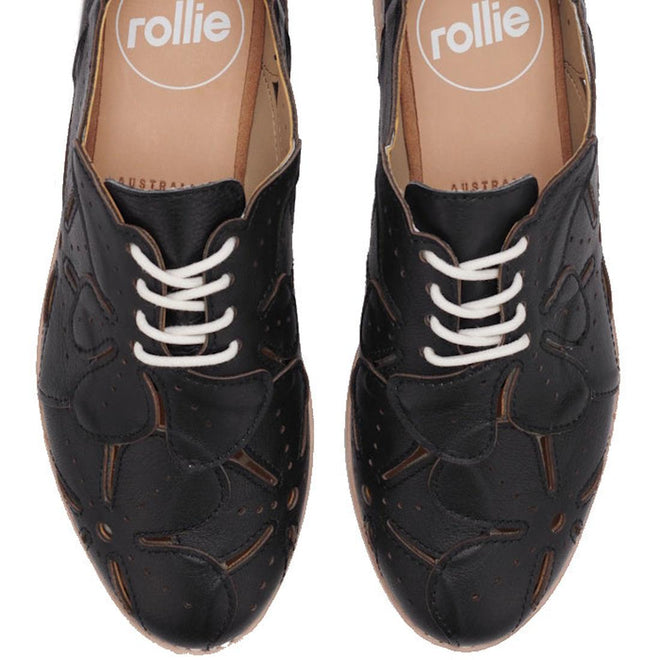 The Rollie Derby Applique Black Womens Leather Brogue Shoe features soft black leather uppers, white laces, and a floral cut-out toe pattern, shown from an overhead view., 9781760792312, 9781760792329, 9781760792336, 9781760792343, 9781760792350