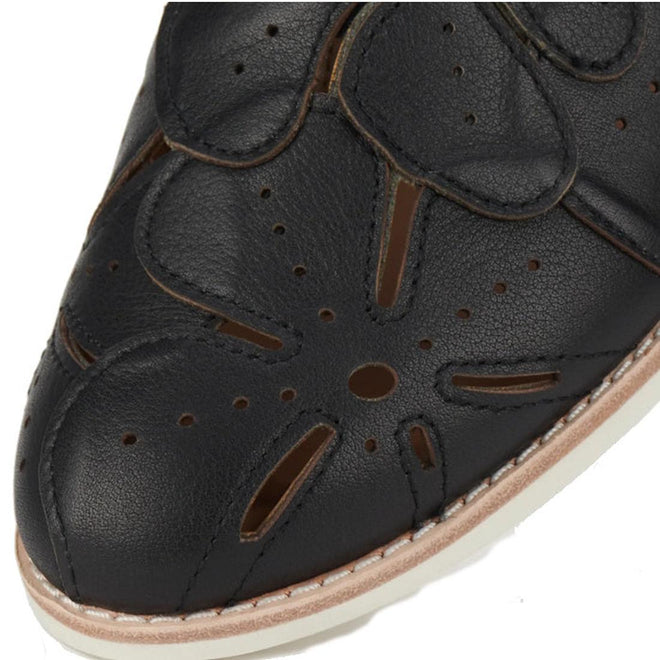 Close-up of the Rollie Derby Applique Black Womens Leather Brogue Shoe—Australian designed in black leather with floral cutout patterns, decorative upper perforations, and a light-toned stitched sole., 9781760792312, 9781760792329, 9781760792336, 9781760792343, 9781760792350