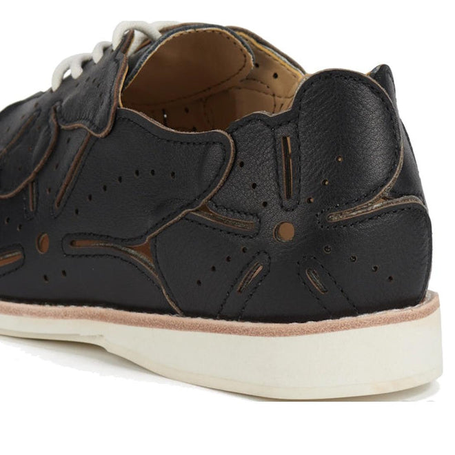 A close-up of the Rollie Derby Applique Black Womens Leather Brogue Shoe shows black leather uppers with floral-shaped perforations, overlays, a white sole, and tan interior lining., 9781760792312, 9781760792329, 9781760792336, 9781760792343, 9781760792350