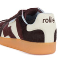 A close-up of the Rollie Womens Pace Dark Cherry Bone Suede Sneaker features a brown and white furry upper, light brown rubber sole, and "rollie" embroidered on the white heel tab., 9339554000315, 9339554000317, 9339554000164, 9339554000056, 9339554000182