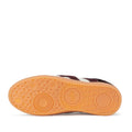 The image shows the orange rubber sole of the Rollie Womens Pace Dark Cherry Bone Suede Sneaker, featuring concentric circles, small raised dots for grip, and "rollie" embossed on its minimalist, textured design., 9339554000315, 9339554000317, 9339554000164, 9339554000056, 9339554000182
