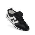 The Rollie Womens Shift Black/Bone Sneaker, model PS00093, stands out with a wavy white side stripe, black suede accents, and a distinctive black flap over the laces, all presented on a crisp white background.