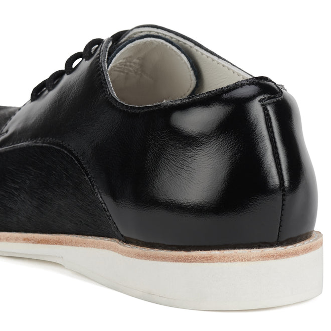 Close-up of the Rollie Womens Derby Black Splice Leather Brogue Shoe: black leather upper, white inner lining, thick white anti-slip rubber outsole, black laces, shiny finish, and a removable orthotic-friendly footbed for comfort., 51190, 9339554014920, 9339554054292, 9339554007458, 9339554000329, 9339554389769