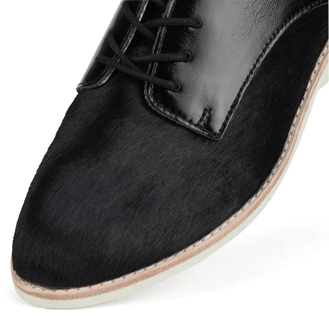 Close-up of the Rollie Womens Derby Black Splice Leather Brogue Shoe, showcasing smooth leather with a textured finish, anti-slip rubber outsole, black laces, and contrast stitching along the sole., 51190, 9339554014920, 9339554054292, 9339554007458, 9339554000329, 9339554389769