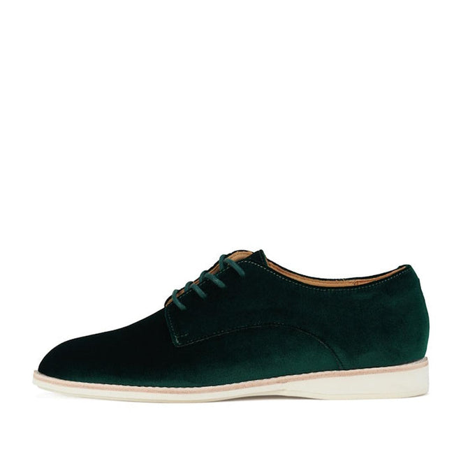 The Rollie Womens Derby Emerald Velvet Brogue Shoe, style SC02101, features dark green velvet and a low-profile white sole, shown in a side view on a white background., 9339554068114, 9339554005690, 9339554000077, 9339554000336, 9339554023830