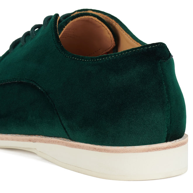 Close-up of the heel and side of the Rollie Womens Derby Emerald Velvet Brogue Shoe, showcasing its dark green velvet upper, white sole, tan leather interior, neat stitching, and smooth finish., 9339554068114, 9339554005690, 9339554000077, 9339554000336, 9339554023830