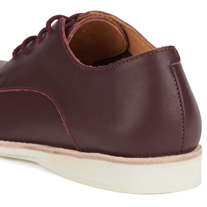 Close-up of the Rollie Womens Derby Super Soft Dark Cherry Leather Shoe, highlighting the smooth leather heel and side, light stitching, cushy EVA midsole, white anti-slip rubber outsole, and part of the open collar., 9339554034843, 9339554086330, 9339554099231, 9339554070285, 9339554124001, 9339554126029