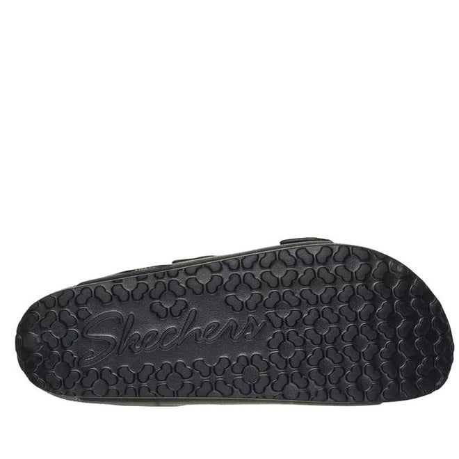 The image shows the black rubber sole of the Skechers Womens Arch Fit Foamies Cali Breeze Gold Star Slide, featuring raised clover shapes and an embossed Skechers logo—ideal for those wanting cushioned footbed sandals., 49587, 197627436340, 197627436357, 197627436364, 197627436371, 49592, 49593