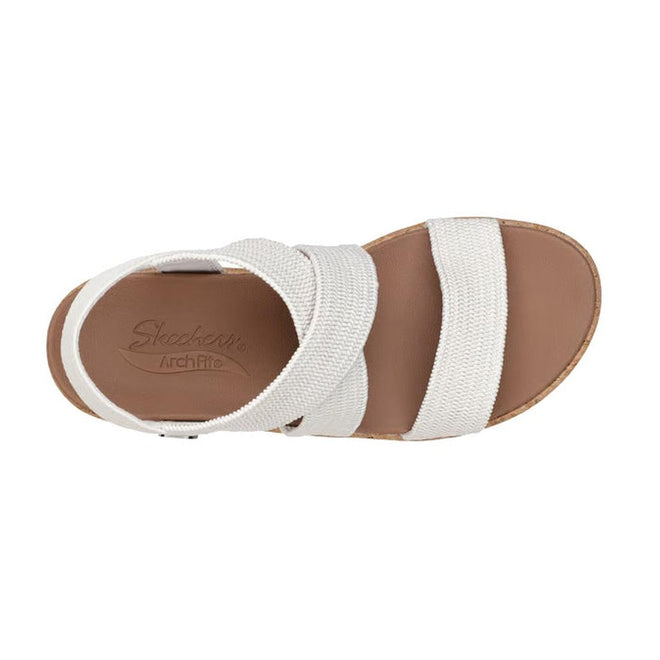 Top view of the Skechers Womens Arch Fit Beverlee Love Stays White Wedge Sandal with a tan memory foam footbed, two wide textured white straps, an ankle strap, and open toe and heel design for stylish comfort., 49607, 195969731529, 195969731543, 195969731567, 195969731581, 195969731598
