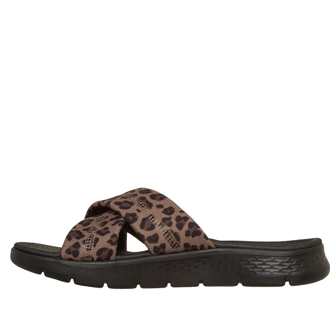 The Skechers Go Walk Flex Sandal Kat Slide Black Leopard is a stylish sandal with a thick black sole and crisscross brown fabric straps adorned with a black leopard print pattern, shown from the side on a white background. Featuring a comfortable Memory Foam footbed, this sandal offers all-day support.