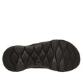 The image shows the black rubber sole of the Skechers GO WALK Flex Sandal Kat Slide Black Leopard, featuring a textured pattern with oval and diamond-shaped treads for enhanced grip and traction.