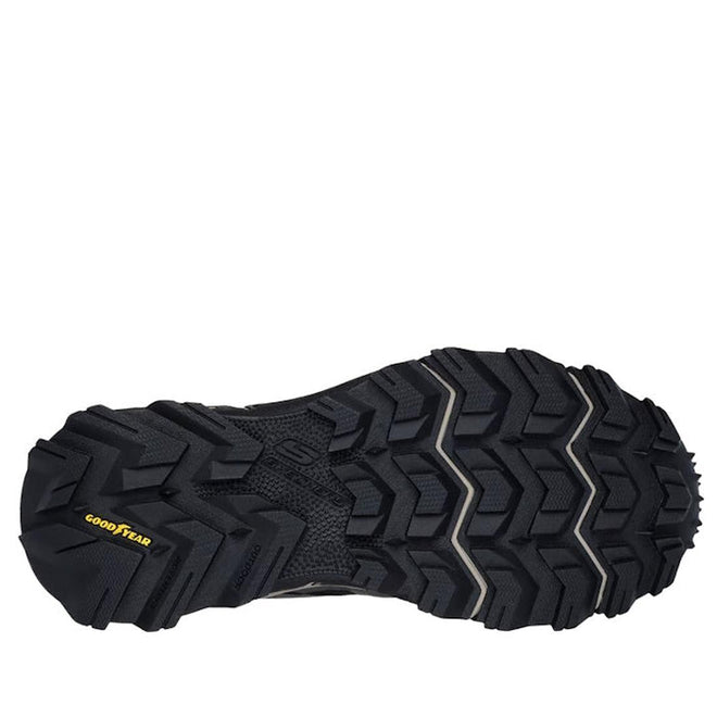 The image shows the black, rugged rubber outsole with deep, angular treads and a yellow Goodyear logo on the heel—built for grip and durability on the Skechers John Deere Equalizer 5.0 Trail Harvester Slip Ins in grey charcoal black., 50557, 50558, 197976615021, 197976615045, 50561