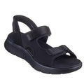 A black Skechers Mens Go Walk Flex SD Easy Entry Slip In Sandals, featuring two adjustable Velcro straps, an open toe, and a thick textured sole for comfort. Inspired by sporty, casual men’s slip-in sandal styles.