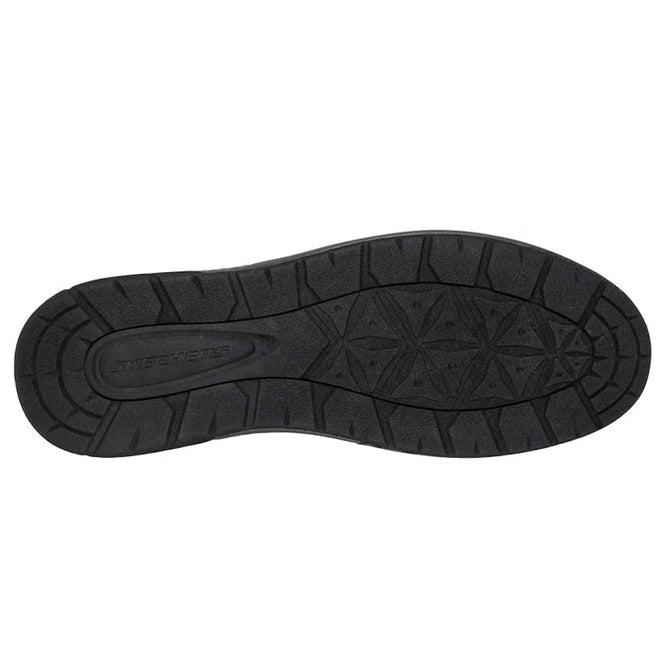 The image shows the black rubber sole of the Skechers Mens EXTRA Wide Width Garlan Pryor Waterproof Slip on Trainer, featuring a textured grip pattern and the word “Skechers” embossed in the center near the heel. This style is designed with an extra wide width for enhanced comfort and support., 53093, 53094, 198739933048, 198739933062, 53097