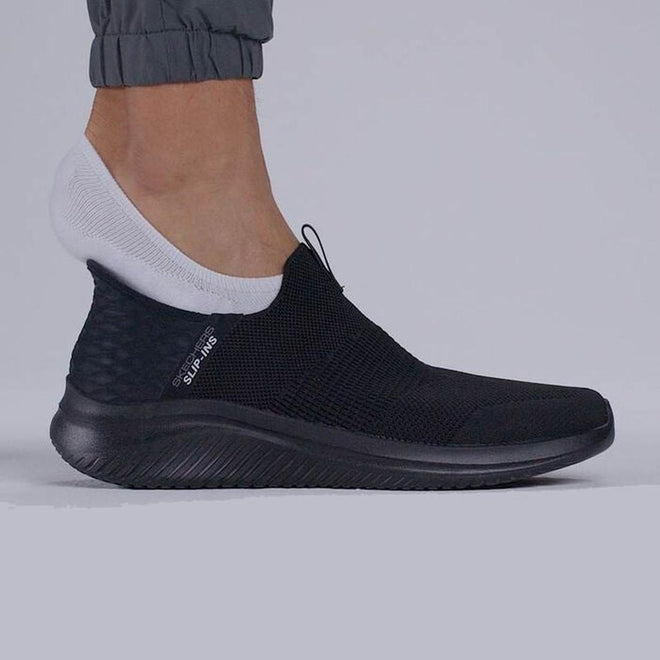 A person in gray jogger pants and white ankle socks wears the Skechers Mens Slip Ins Ultra Flex 3.0 Viewpoint shoe, featuring a textured sole, mesh upper, and Air-Cooled Memory Foam, standing on a light gray surface., 38456, 196311463709, 196311463723, 38459, 38460, 196642911429, 196642911443, 196642911467