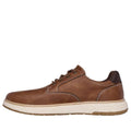 The Skechers Men's Wide Width Garlan Pryor is a waterproof slip-on trainer in brown, designed with Relaxed Fit comfort, white stitching, and a thick off-white textured sole., 52100, 52101, 198376435479, 198376435493, 198376435516