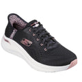 The Skechers Arch Fit 2.0 Slip In Spotted Grace Black Multi is a black vegan sneaker with light pink accents, a white sole, leopard print lining, mesh upper, and lace-up closure for stylish comfort.