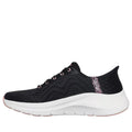 The Skechers Arch Fit 2.0 Slip In Spotted Grace Black Multi is shown from the left side, featuring a black breathable mesh upper, white sole, patterned pink and black accents on the tongue and heel, and black laces with pink details., 199025299961, 48851, 199025299985, 48853, 199025300001, 48855, 199025300025, 48857, 199025300049, 199025300063