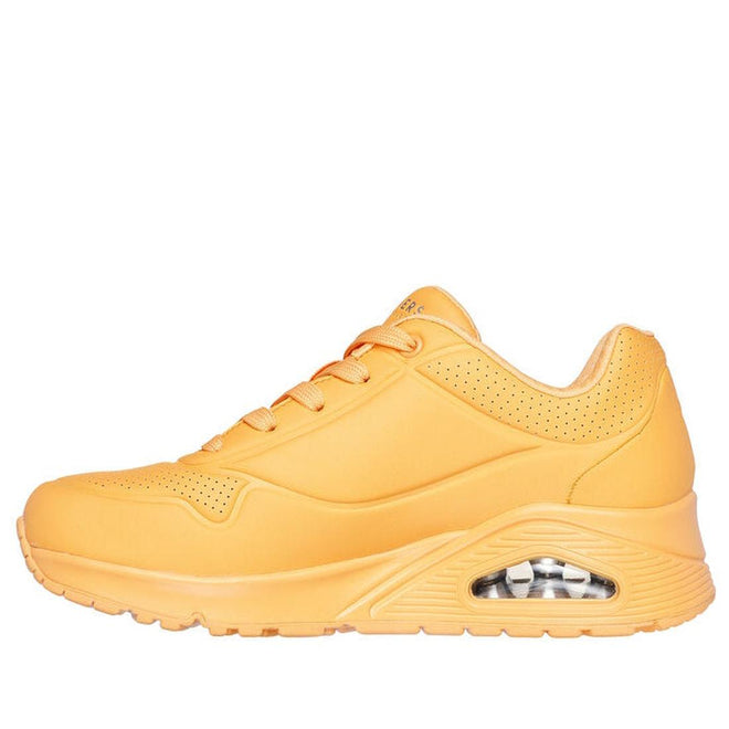 A side view of the Skechers Uno Stand On Air Womens Trainer in orange, featuring visible air-cushion sole, orange laces, perforated ankle for ventilation, and Air-Cooled Memory Foam for comfort., 42039, 42040, 193642531305, 42042, 193642531329, 42044, 193642531343, 42046, 42047, 42048