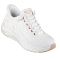 The Skechers Womens Slip In Contour Foam Golden Hour Cozy Fit in white and rose gold features blush pink accents, quilted pattern, Air-Cooled Memory Foam comfort, and "Skechers Hands Free Slip-ins" branding.